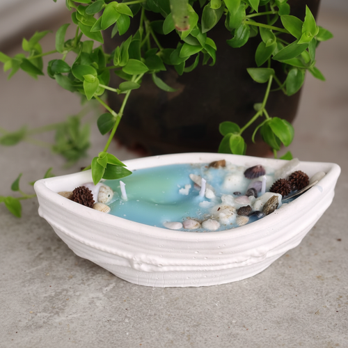 Boat concrete candle with ocean blue wax and shells - enhanced product photo